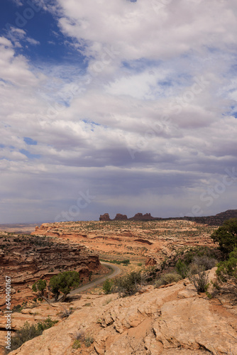 wide landscape of red mountains with weather on the horizon