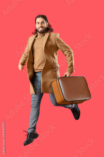 Jumping man with suitcase o...