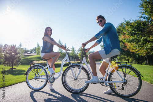 Couple cycling in park