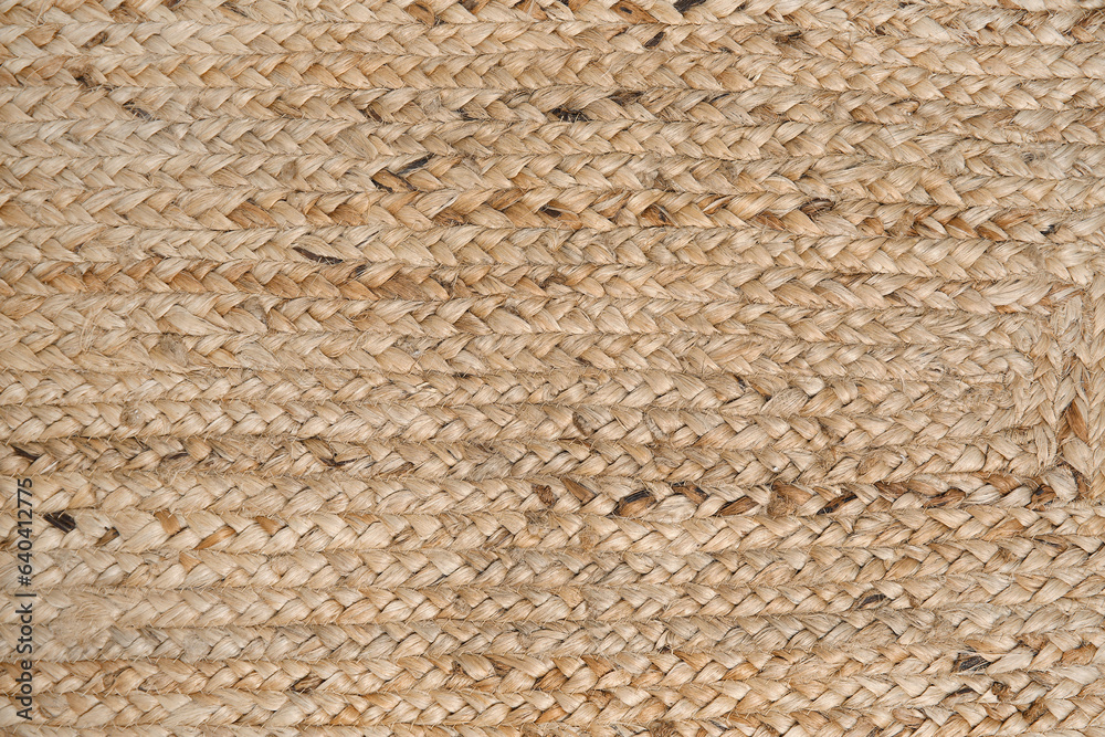 Closeup view of stylish wicker rug as background Closeup view of stylish wicker rug as background