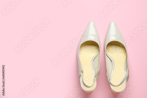 Stylish grey high heels on pink background