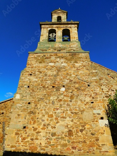 Parish of the Assumption, Villalís de la Valduerna, León. Vibrant Rural Landscape with Blue Sky and Architectural Background photo