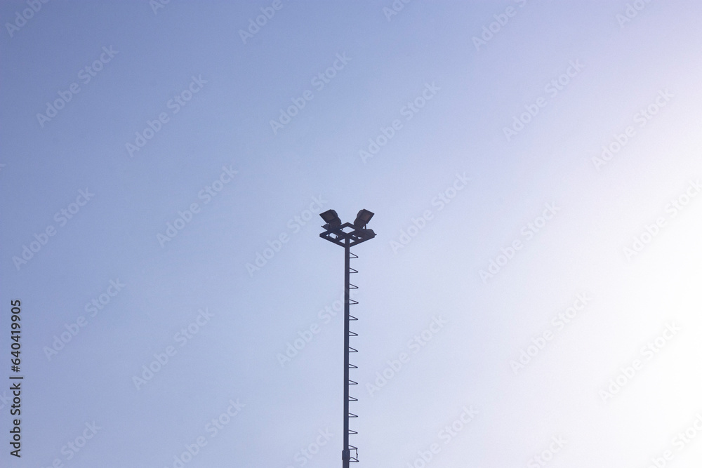 Photograph of a lighting pole in an open field.
