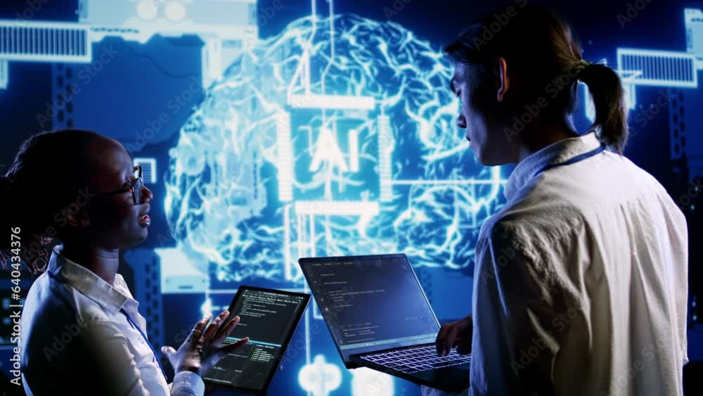 Teamworking colleagues updating AI systems, writing intricate binary code scripts on tablet and laptop. Qualified engineers using programming to upgrade artificial intelligence simulation model