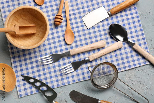 Different kitchen utensils on grey background