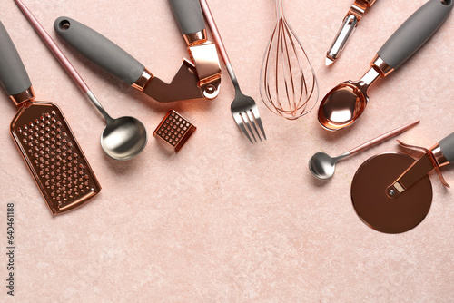 Different kitchen utensils on pink background