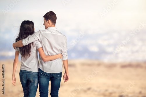 Happy couple walking on beach sand