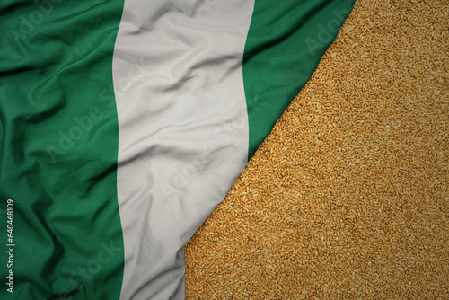 Obraz na plátně wheat grain on the waving colorful big national flag of nigeria .