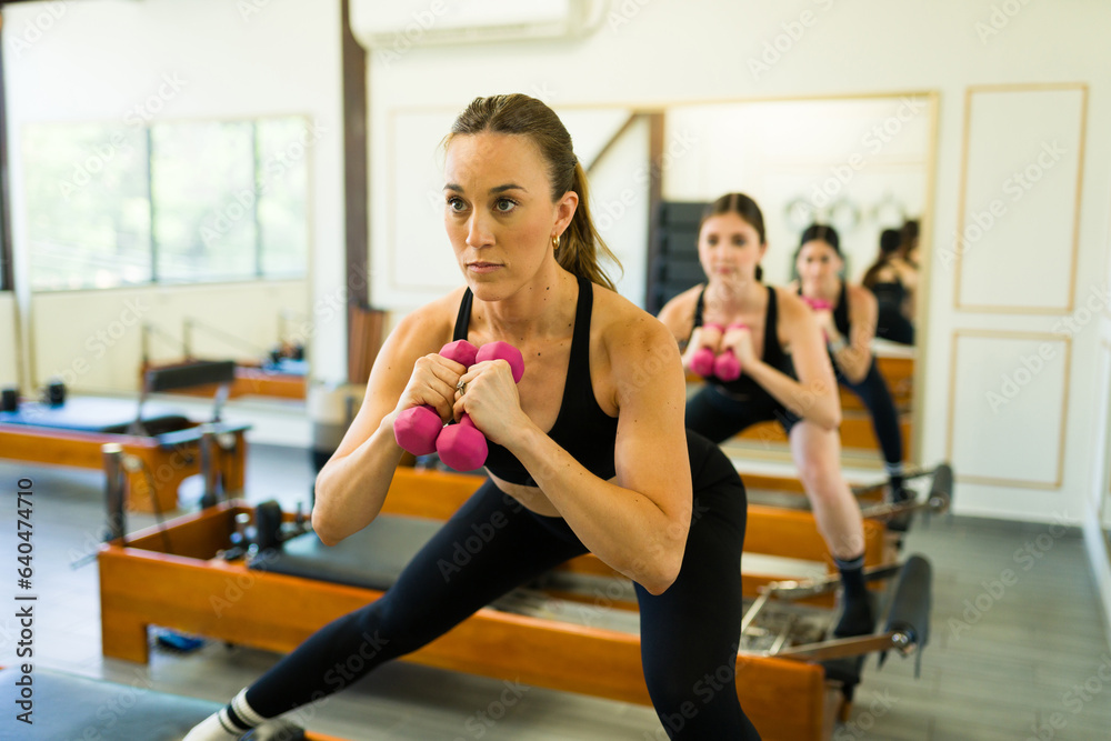 Young women working out core stability balance at pilates