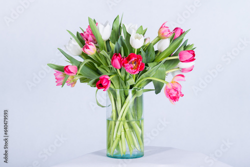 Many kinds of beautiful flowers put in vase on a white background