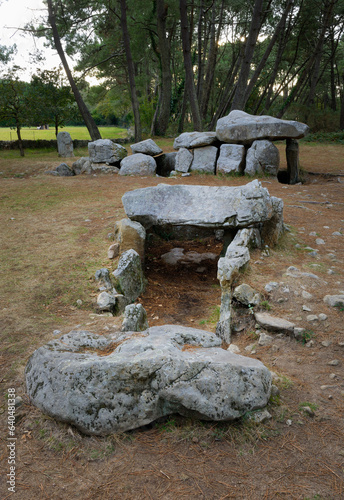 Neolithic dolmen burial chamber complex of Mane Kerioned. Brittany, France. The western passage grave behind the central dolmen photo