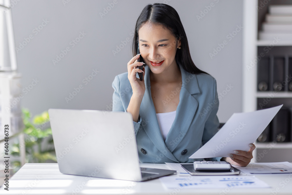 Financial Business Asian women analyze graph of the company's performance to create profits and growth, Market research reports and income statistics by call phone, Financial and Accounting concept. Financial Business Asian women analyze graph of the company's performance to create profits and growth, Market research reports and income statistics by call phone, Financial and Accounting concept.
