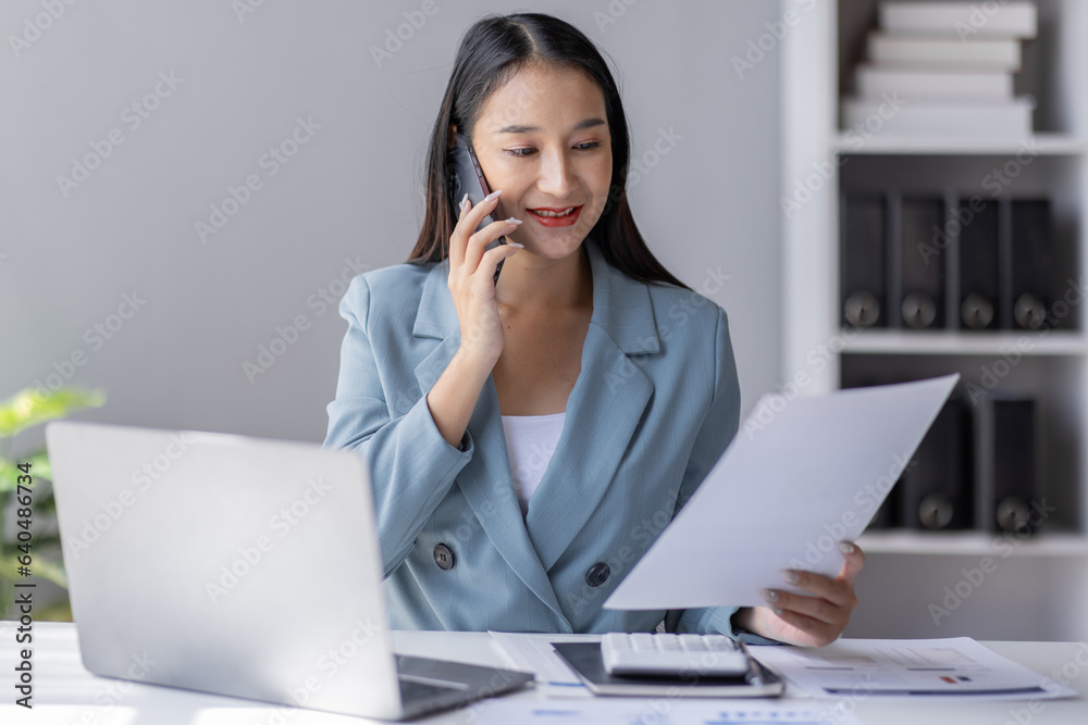 Financial Business Asian women analyze graph of the company's performance to create profits and growth, Market research reports and income statistics by call phone, Financial and Accounting concept. Financial Business Asian women analyze graph of the company's performance to create profits and growth, Market research reports and income statistics by call phone, Financial and Accounting concept.