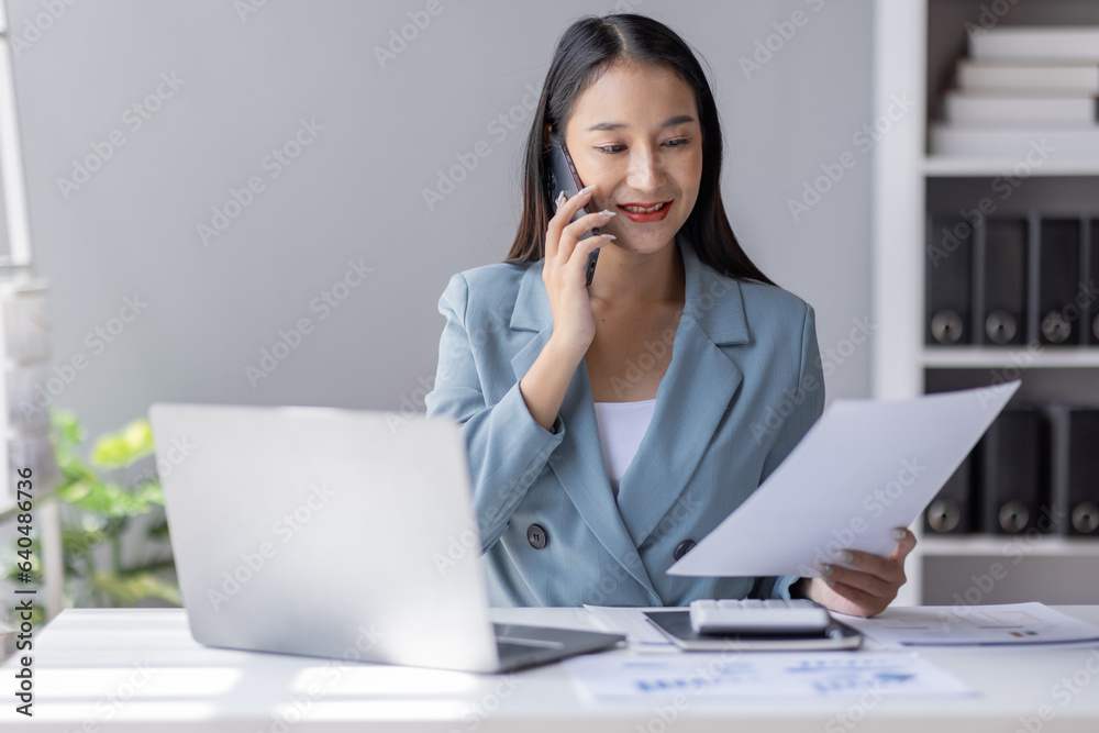 Financial Business Asian women analyze graph of the company's performance to create profits and growth, Market research reports and income statistics by call phone, Financial and Accounting concept. Financial Business Asian women analyze graph of the company's performance to create profits and growth, Market research reports and income statistics by call phone, Financial and Accounting concept.