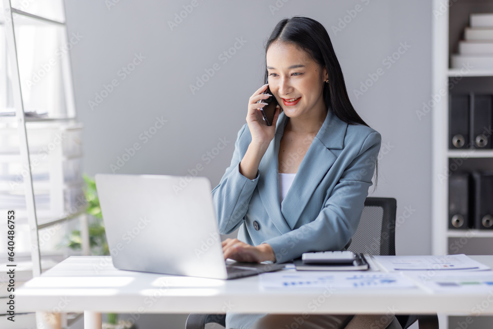 Financial Business Asian women analyze graph of the company's performance to create profits and growth, Market research reports and income statistics by call phone, Financial and Accounting concept. Financial Business Asian women analyze graph of the company's performance to create profits and growth, Market research reports and income statistics by call phone, Financial and Accounting concept.