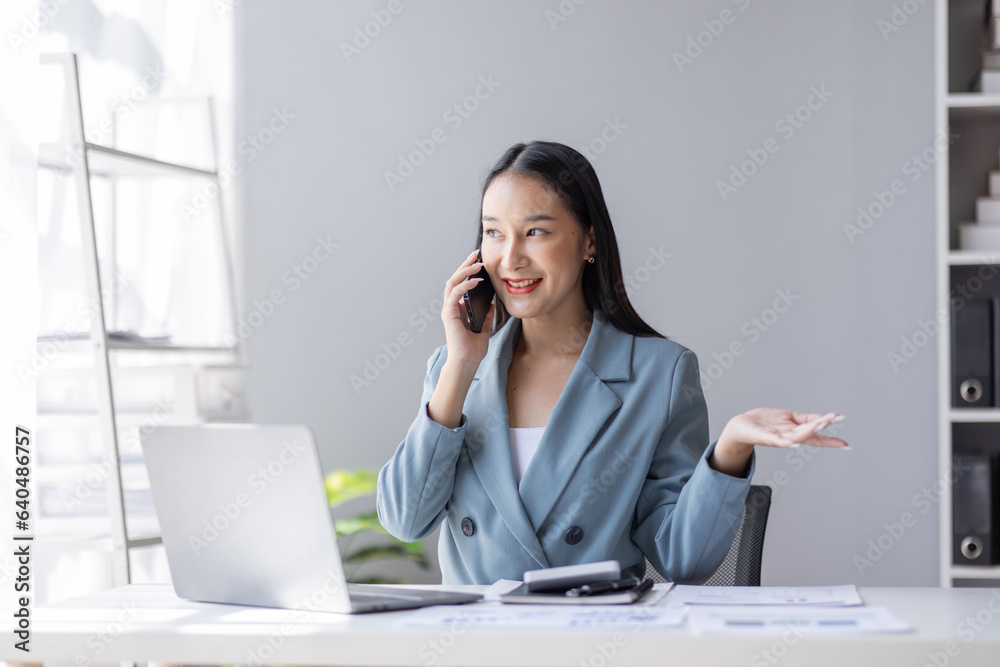 Financial Business Asian women analyze graph of the company's performance to create profits and growth, Market research reports and income statistics by call phone, Financial and Accounting concept. Financial Business Asian women analyze graph of the company's performance to create profits and growth, Market research reports and income statistics by call phone, Financial and Accounting concept.