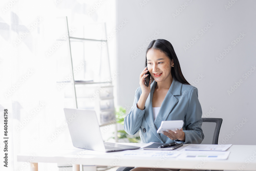 Financial Business Asian women analyze graph of the company's performance to create profits and growth, Market research reports and income statistics by call phone, Financial and Accounting concept. Financial Business Asian women analyze graph of the company's performance to create profits and growth, Market research reports and income statistics by call phone, Financial and Accounting concept.
