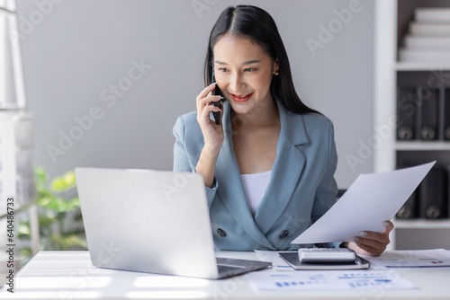 Financial Business Asian women analyze graph of the company's performance to create profits and growth, Market research reports and income statistics by call phone, Financial and Accounting concept.