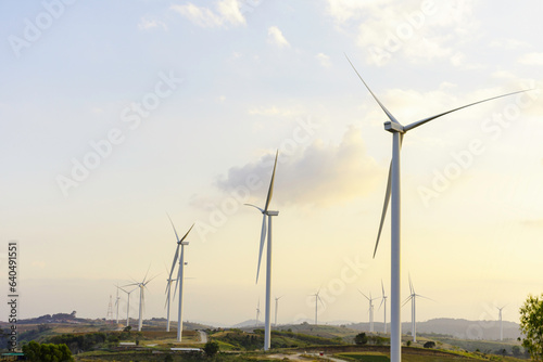 Windmill turbine farm for electricity generation on landscape mountain at sunset sky, Green power industry resouces, Sustainable and clean energy generator from wind and frieldly with enviroement