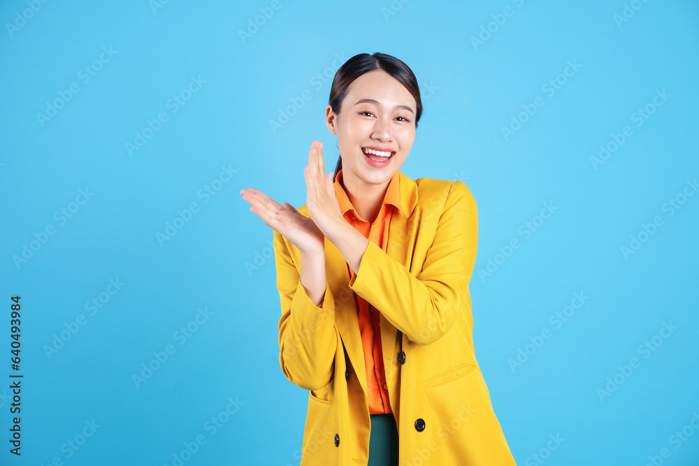 Photo of young Asian businesswoman with colorful suit on background Photo of young Asian businesswoman with colorful suit on background