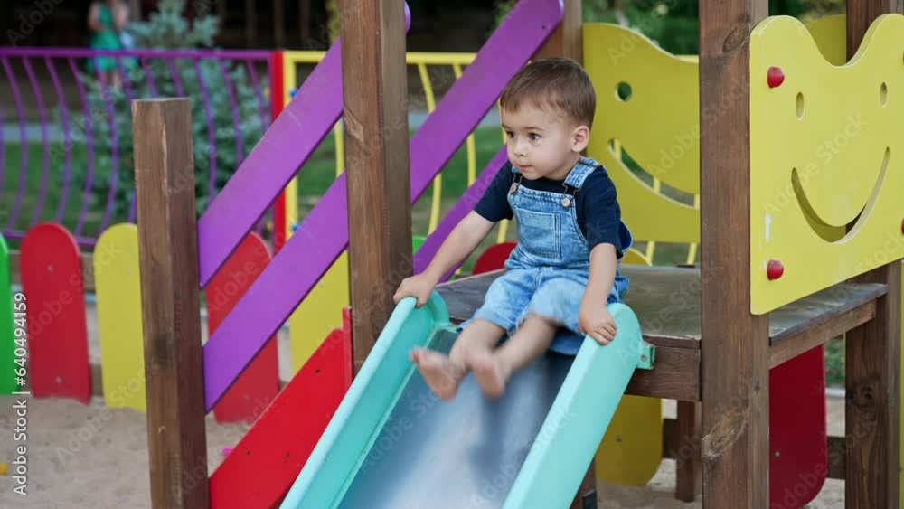 Small boy playing on playground. Child on colorful kindergarten. Small boy playing on playground. Child on colorful kindergarten.
