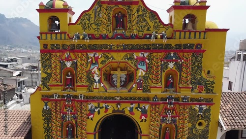 Ornate detail of bright yellow Mayan Church façade in San Andres Xecul photo