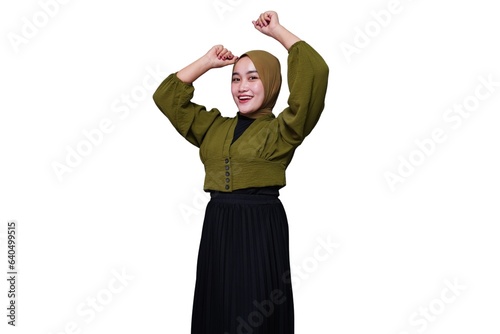 Excited young asian hijab woman dancing to her favourit music
 photo