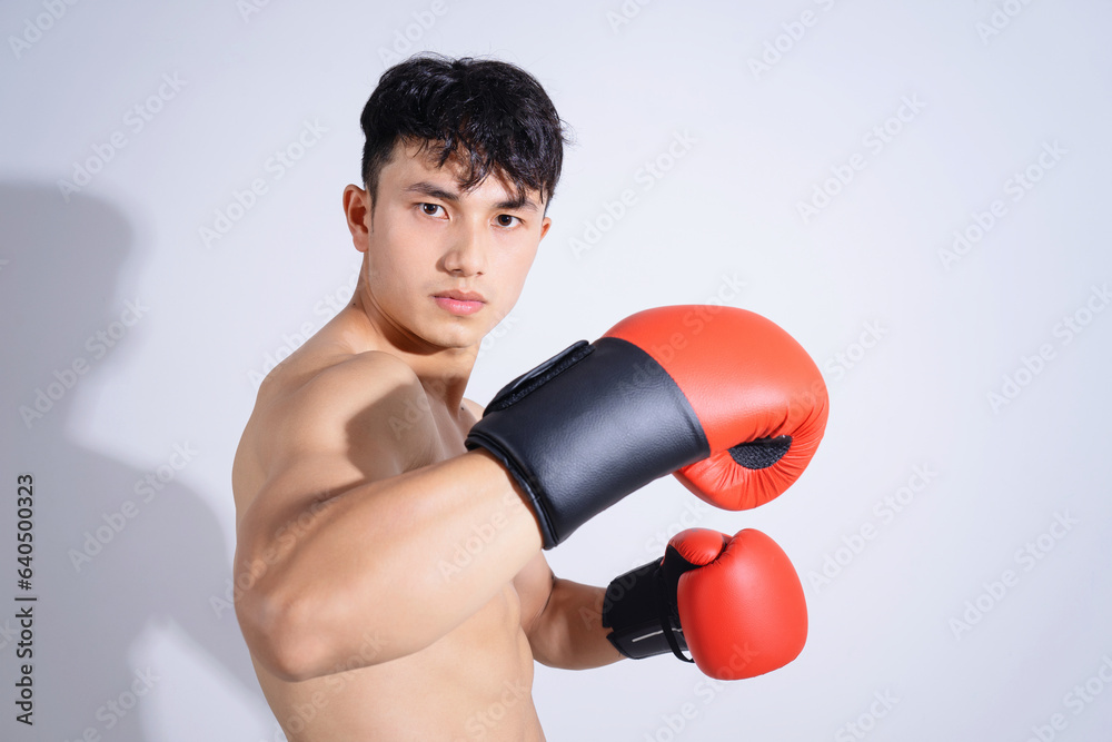 Photo of young Asian boxer on white background Photo of young Asian boxer on white background