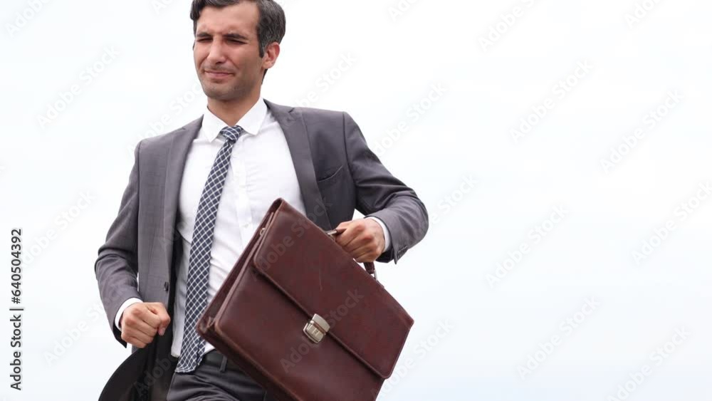 Studio shot of a mature businessman running with a briefcase isolated against the sky. Studio shot of a mature businessman running with a briefcase isolated against the sky.