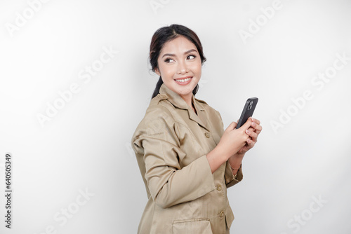 Smiling government worker woman holding her smartphone. PNS wearing khaki uniform.