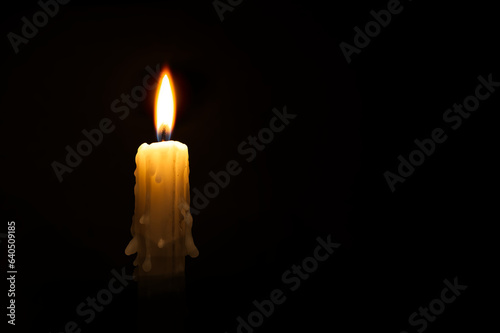 Close-up of a candle flame against a black background photo