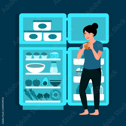 Hungry female standing in front of opened fridge eating food at night. Woman with night eating syndrome.