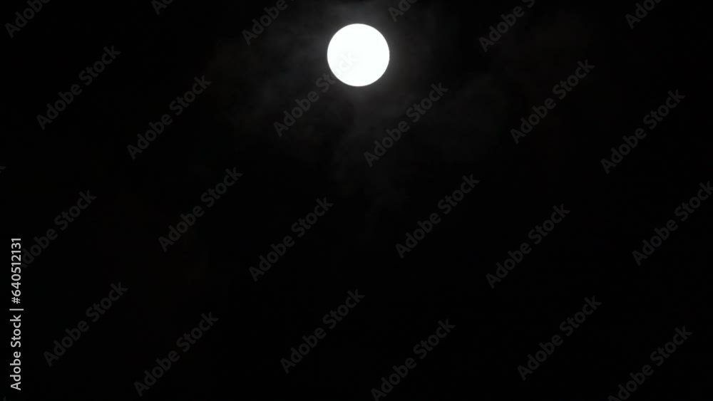 Timelapse of full moon rising vertically in dark black sky, moon lapse Timelapse of full moon rising vertically in dark black sky, moon lapse