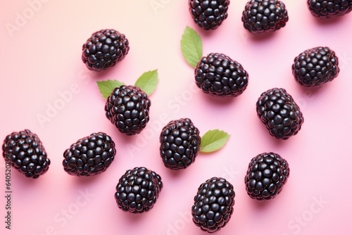 Top view of blackberry fruits on pastel pink background