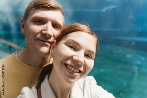 Selfie portrait of satisfied aquarium visitors, woman and man sm