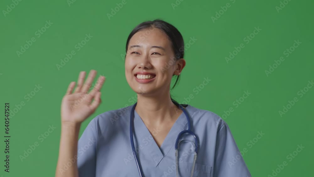 Close Up Of Asian Female Doctor With Stethoscope Waving Hand And Smiling While Walking On Green Screen Background In The Hospital
Close Up Of Asian Female Doctor With Stethoscope Waving Hand And Smiling While Walking On Green Screen Background In The Hospital