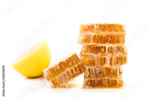 sweet honeycombs with lemon isolated on white background