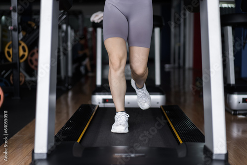 Attractive young sports woman working out in gym, cardio training on treadmill running on treadmill