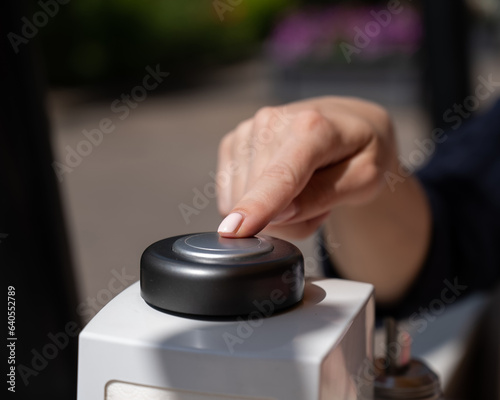 Woman pressing button to call waiter in cafe. 