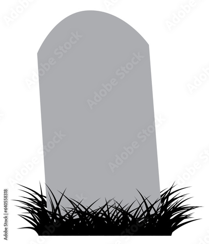 Grey tombstone on clump of black grass.