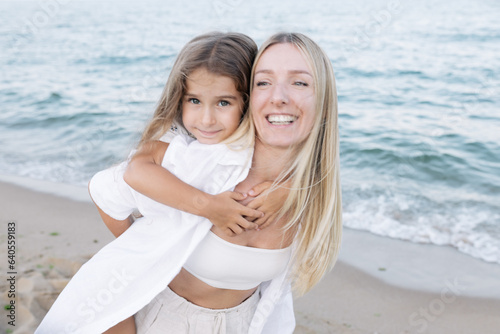 Mother's love for daughter. Mother and daughter play near the sea