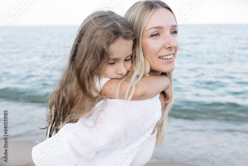 Mother's love for daughter. Mother and daughter play near the sea