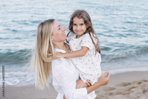 Mother's love for daughter. Mother and daughter play near the sea