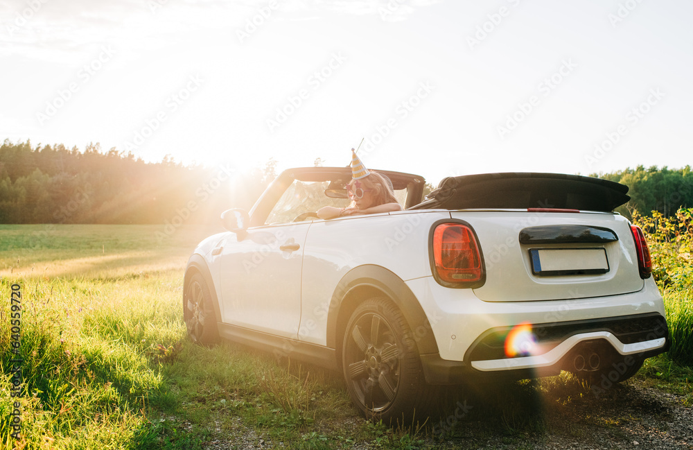 girl sat in convertible mini looking tired after a party girl sat in convertible mini looking tired after a party