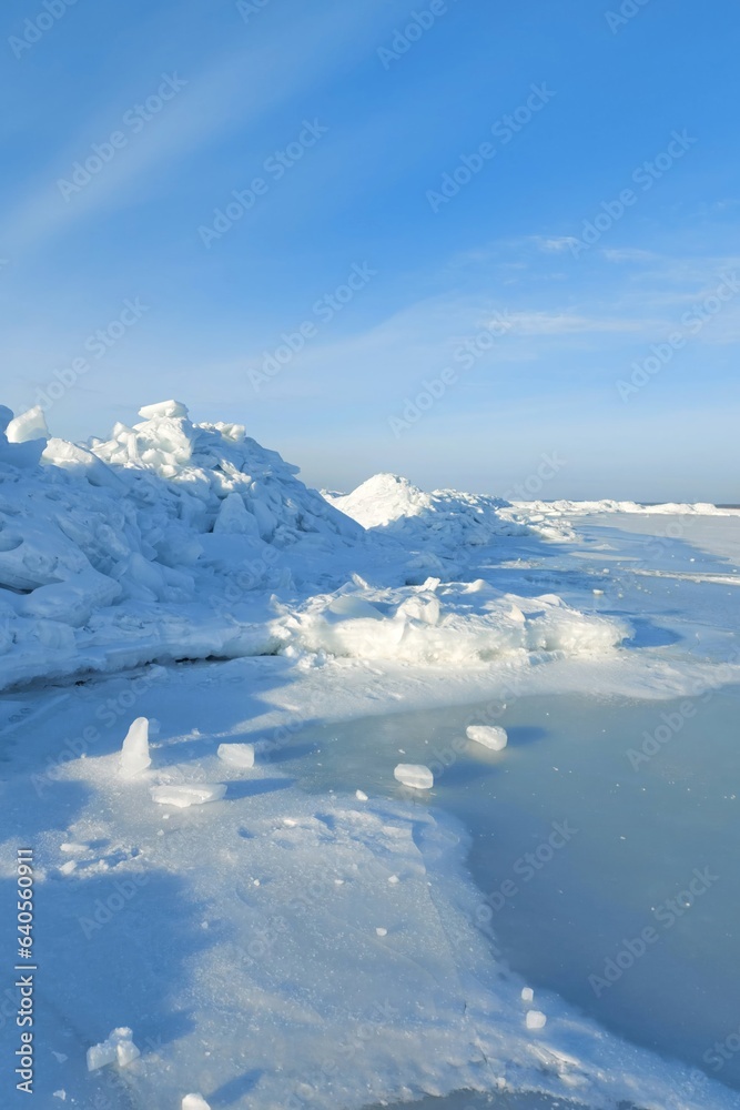 The Baltic Sea The Gulf of Riga in winter. The bay is covered with ice with small pieces of ice. Latvian winter at Ainazu beach