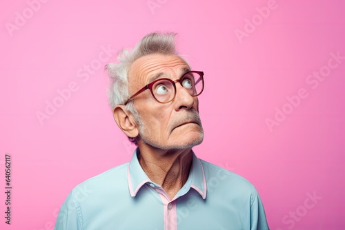Pensive elderly man gazes upward with raised eyebrows. Photo generative AI