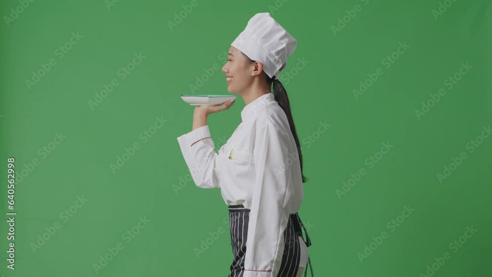 Side View Of Asian Woman Chef Holding A Dish While Walking In The Green Screen Background Studio
Side View Of Asian Woman Chef Holding A Dish While Walking In The Green Screen Background Studio
