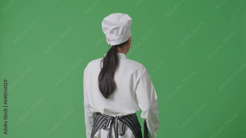 Back View Of Asian Woman Chef Holding A Tablet While Walking In The Green Screen Background Studio
Back View Of Asian Woman Chef Holding A Tablet While Walking In The Green Screen Background Studio