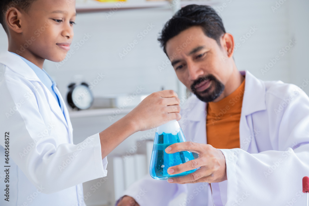 Curiosity African Asian primary school boy student wearing lab coats happy studying with chemical teacher analyzing substance liquid test in laboratory room, lifestyle learning education science class Curiosity African Asian primary school boy student wearing lab coats happy studying with chemical teacher analyzing substance liquid test in laboratory room, lifestyle learning education science class
