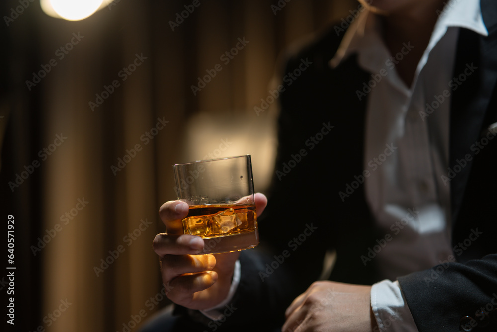 Businessmen in suits drinking whiskey